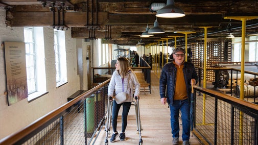 Visitors inside the mill at Quarry Bank